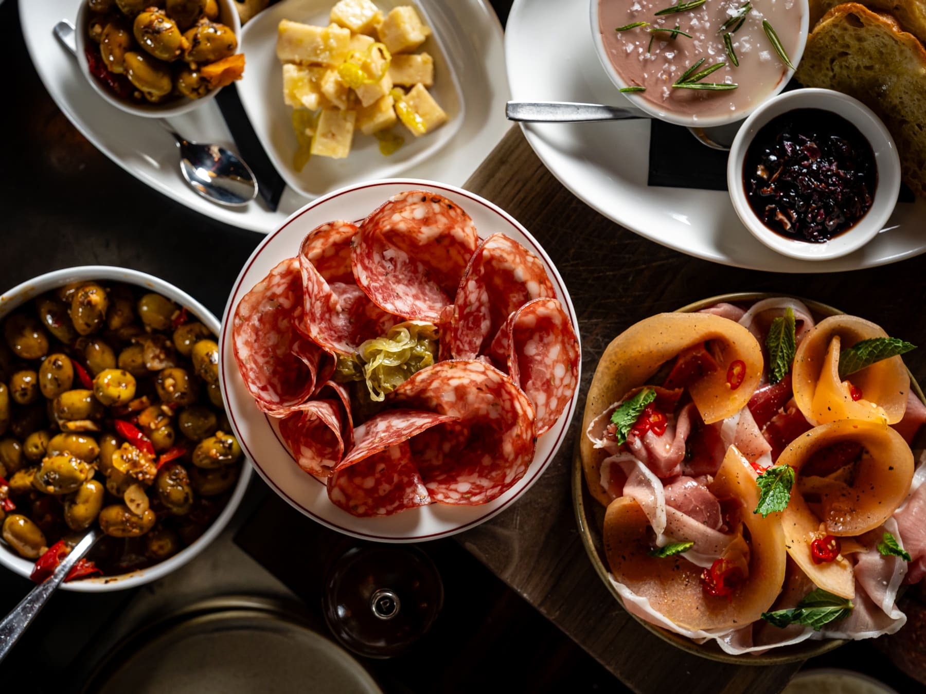 Aperitivo spread with salumi, olives, and wine at Notte