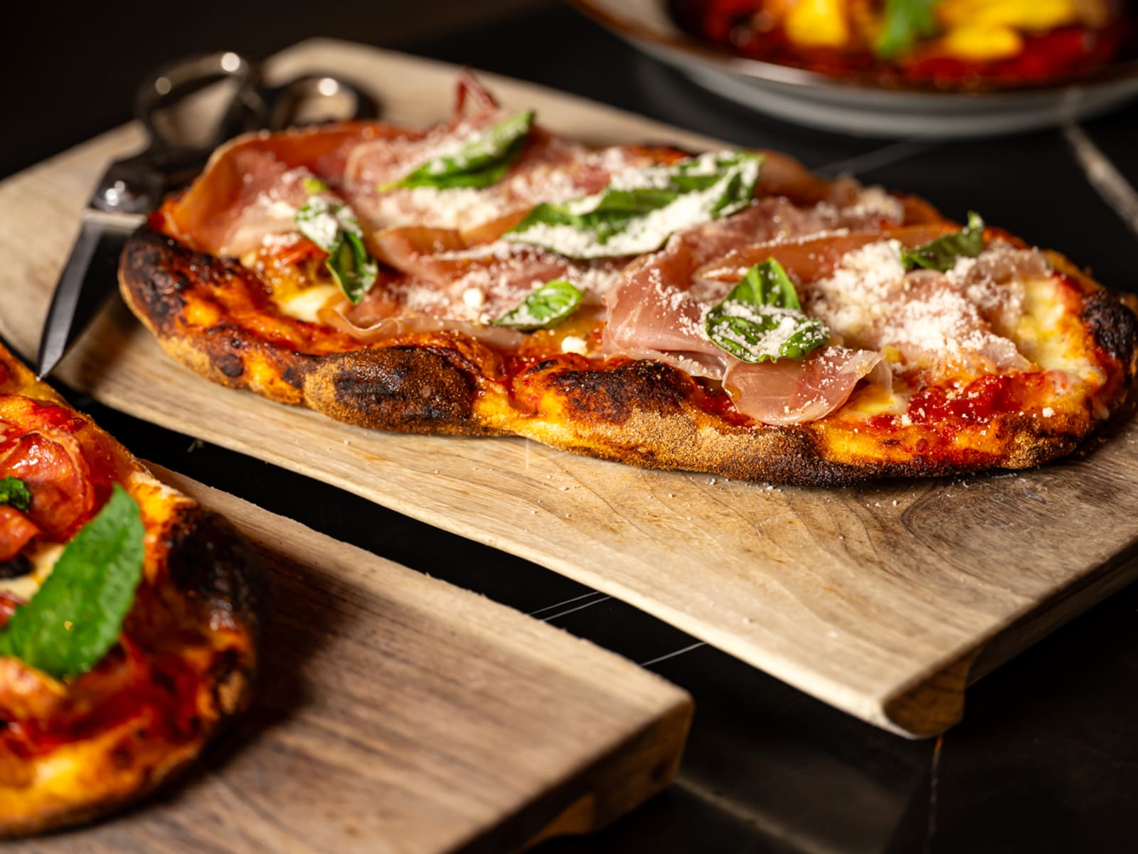 Roman-style pizza served on a wooden board at Notte